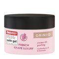 A container of ORINIQ French Grape Luxury cream-oil scrub with the ÖKO-TEST logo indicating a high rating, and the product name and description.