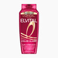 A bottle of L'Oréal Paris Elvital Color Shine 2-in-1 Color Protection Shampoo in a translucent magenta pink bottle with gold and white lettering, set against a plain white background.