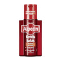 Bottle of Alpecin Double Effect Caffeine shampoo with a red label and a clear display of the product name and features.
