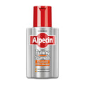 A bottle of Alpecin Tuning Shampoo with a red cap on a white background.