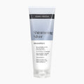 A tube of John Frieda Shimmering Silver Shampoo, featuring a white and light blue-gray design with black text, set against a plain light gray background.