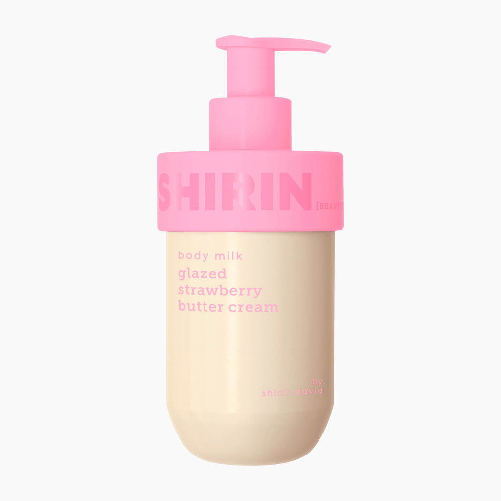 A bottle of Shirin Beauty Glazed Strawberry Butter Cream body milk with a pink pump dispenser and a beige body, labeled 'glazed strawberry butter cream' on a light gray background.