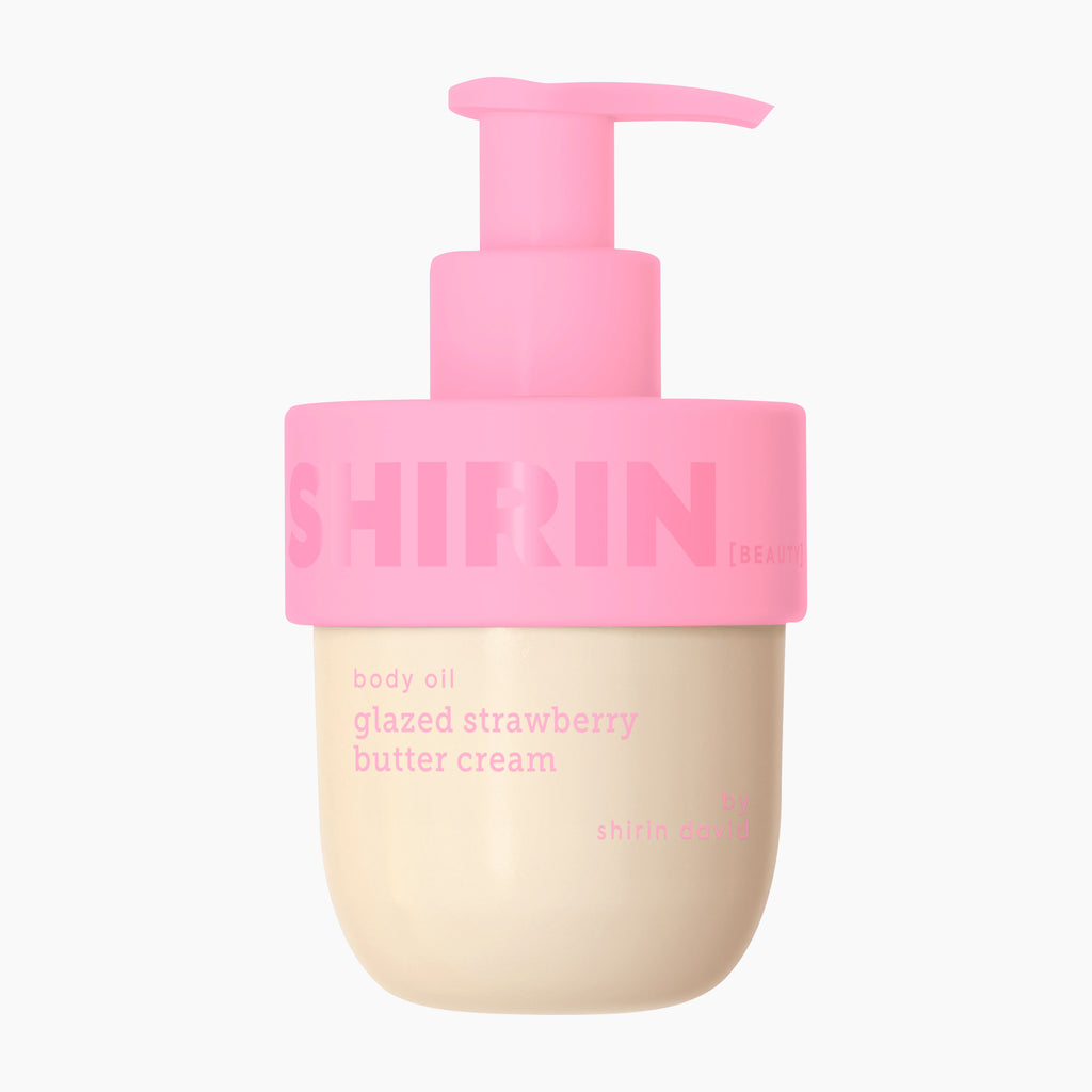 A bottle of Shirin Beauty Glazed Strawberry Butter Cream body oil, featuring a light pink pump dispenser and a beige-colored bottle body with pink text, set against a plain white background.