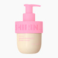 A bottle of Shirin Beauty Glazed Strawberry Butter Cream body oil, featuring a light pink pump dispenser and a beige-colored bottle body with pink text, set against a plain white background.