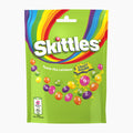 A bag of Skittles Crazy Sours candy in a bright lime green package with a rainbow graphic and colorful Skittles candies illustrated on the front.