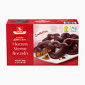 A 500g box of Weiss Dark Chocolate Covered Soft Gingerbread Hearts Stars Pretzels on a clean white background. The packaging is primarily red with a photo of heart-shaped chocolate sprinkles on a white plate.