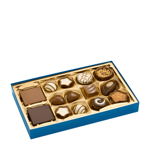 Assorted chocolates in a blue and gold box on a white background
