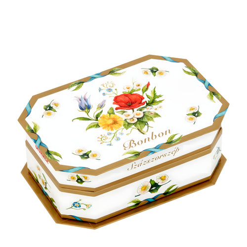 Hexagonal candy box with floral design of Stuhmer Daisy Pralines on a white background