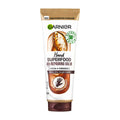 Garnier Superfood 48h Repairing Hand Balm in a tube with brown and white packaging, featuring cocoa butter and ceramides as ingredients.