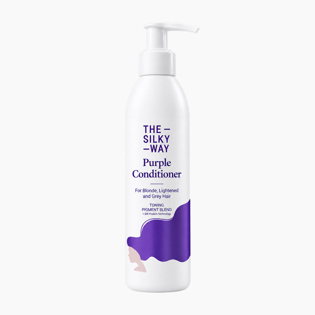 A white pump bottle of 'The Silky Way' Purple Conditioner with purple text and a purple hair graphic on a light gray background.