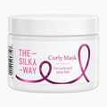The Silky Way Curly Mask plastic jar on a light gray background.