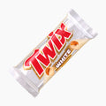 A Twix White biscuit bar in its original wrapper, shown diagonally on a clean white background. The wrapper is white with a large red and gold Twix logo and a small image of the white chocolate cookie with caramel.