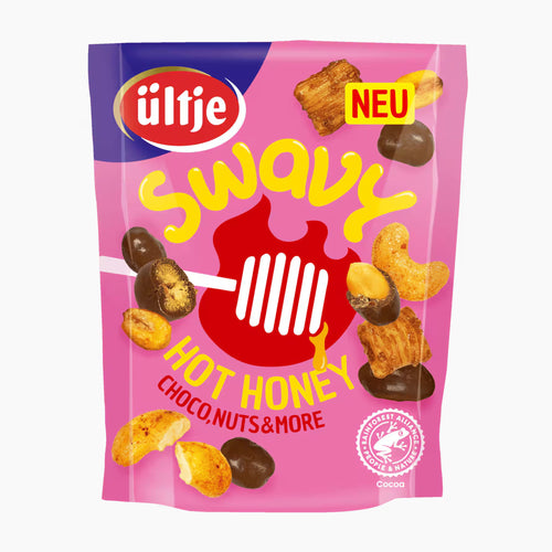 A package of ültje Swavy Hot Honey Choco Nuts & More, featuring a bright pink bag with yellow lettering, a red honeycomb graphic, and illustrations of chocolate-covered and plain nuts.