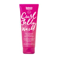 Pink shampoo tube labeled 'Umberto Giannini Curl Jelly Wash' on a white background