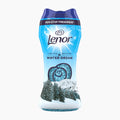 A bottle of Lenor Winter Dream laundry perfume pearls, featuring a blue and white winter-themed design with a snowy mountain and pine forest graphic, on a light gray background.