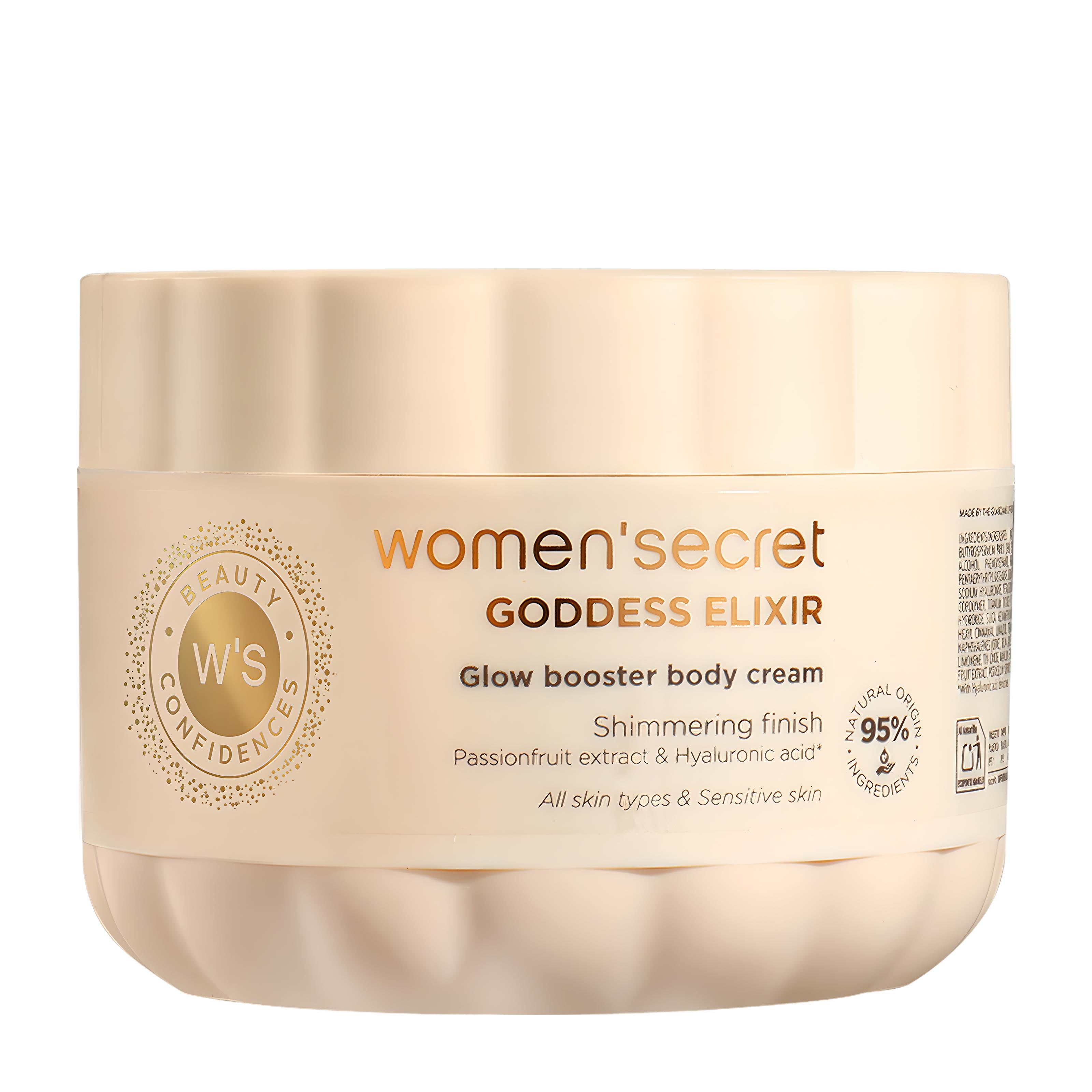 A beige jar of Women'Secret Goddess Elixir Glow Booster Body Cream on a plain white background.
